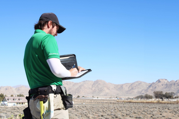 adjuster taking notes in desert