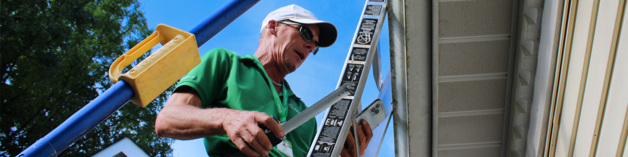 inspector on ladder measuring