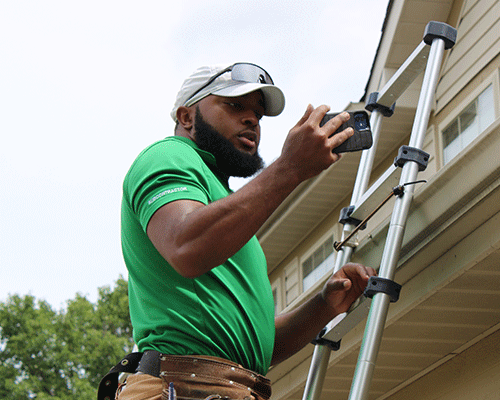 inspector taking photo on a ladder