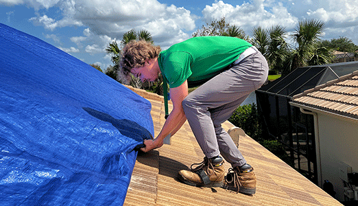 inspector tarping a roof