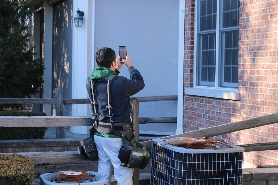 inspector taking photo of gutter